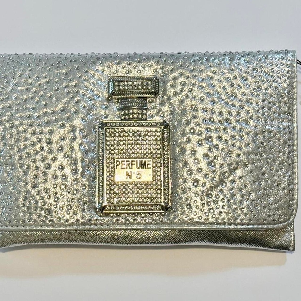 Silver clutch with rhinestone perfume bottle design